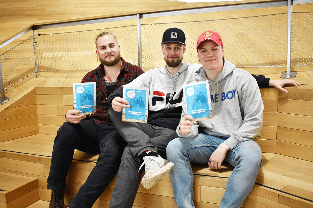 Kolme Diakonia-ammattikorkeakoulun opiskelijaa näyttävät Luotu liikkumaan -oppaita, jotka he ovat tehneet osana opinnäytetyötään.