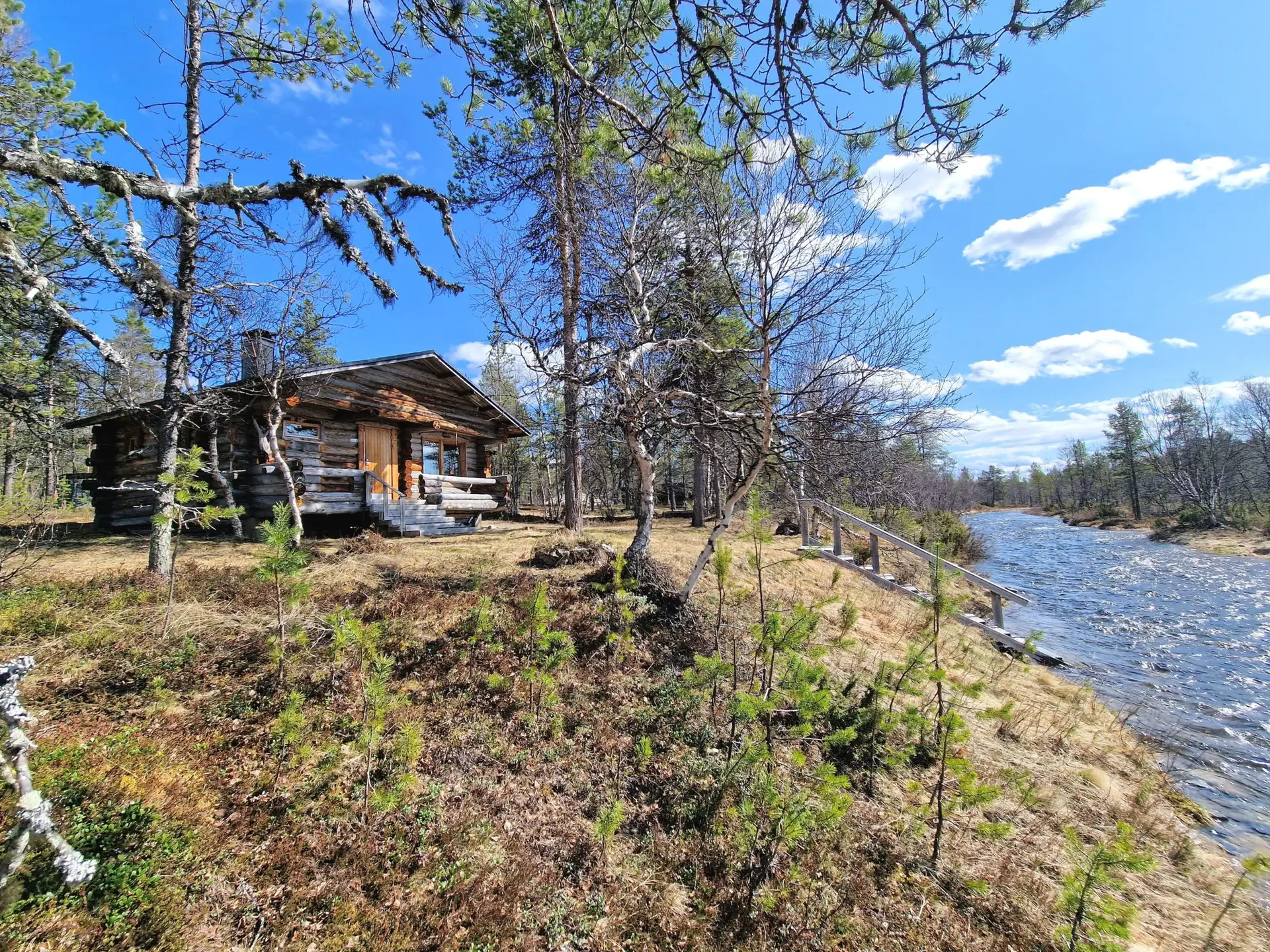 Hirsimökki puron äärellä.
